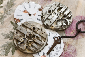 old pocket watch on handmade paper with leaves