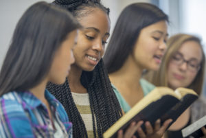 girls reading Bible worship
