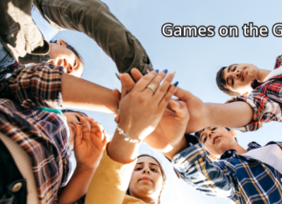 Teens standing in a circle with their hands in the center