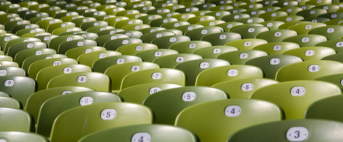 A group of numbered chairs in an auditorium.